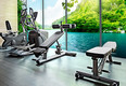Empty gym room with group of exercise machine.